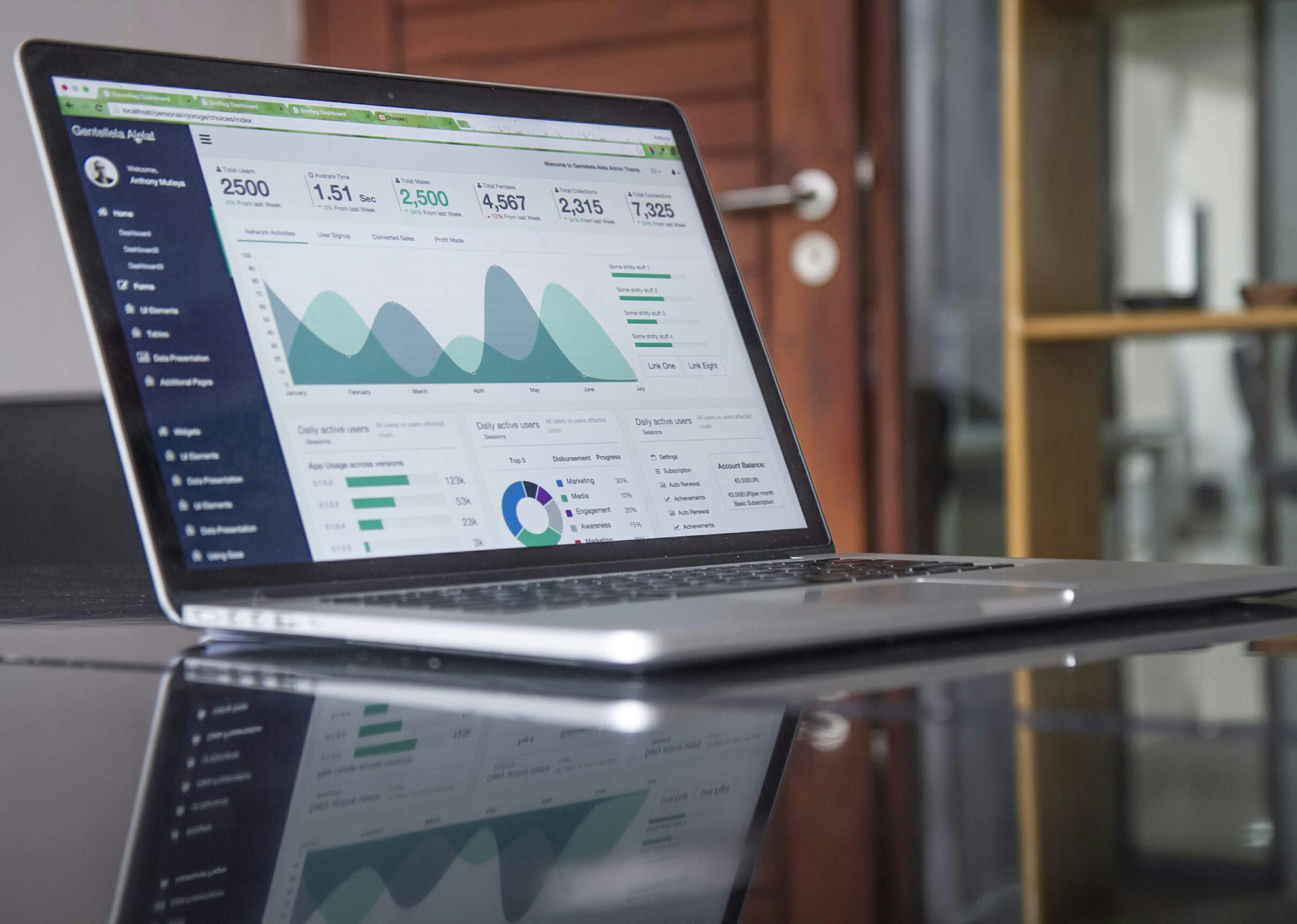 A man sits at a desk with a laptop and notepad, smiling. A graph shows cash flow trends with a current balance of $10,000.